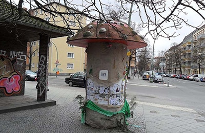 Litfasssäule, die aussieht wie ein Fliegenpilz.